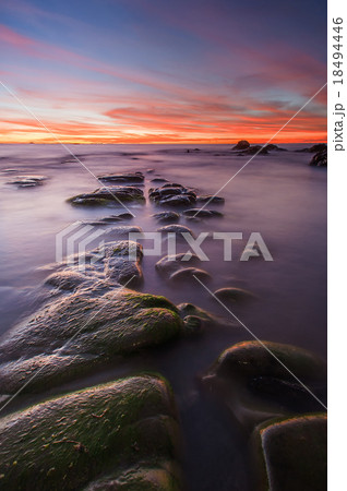 orange sunset over natural Rock line formation 18494446