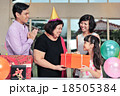 Grandma wearing a party hat at her birthday party 18505384