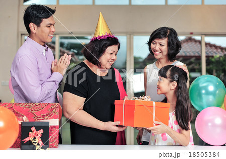 Grandma wearing a party hat at her birthday party 18505384