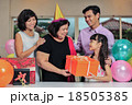 Grandma wearing a party hat at her birthday party 18505385