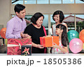 Grandma wearing a party hat at her birthday party 18505386