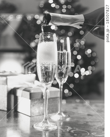 two champagne glasses on Christmas table two champagne glasses on Christmas table 18507827