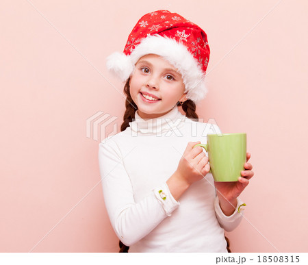 girl with cup in Santa Claus hat girl with cup in Santa Claus hat 18508315