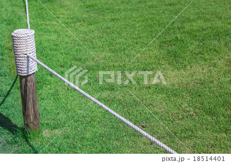 Layers of rope tied around a wooden log Layers of rope tied around a wooden log 18514401