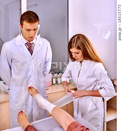 Doctor bandaging patient in hospital. 18515773
