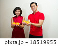 Asian couple dressed in red with oranges for CNY 18519955