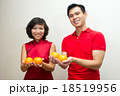 Couple offering oranges as good fortune during CNY 18519956