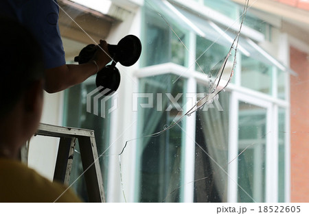 Repair man working on broken glass Repair man working on broken glass 18522605
