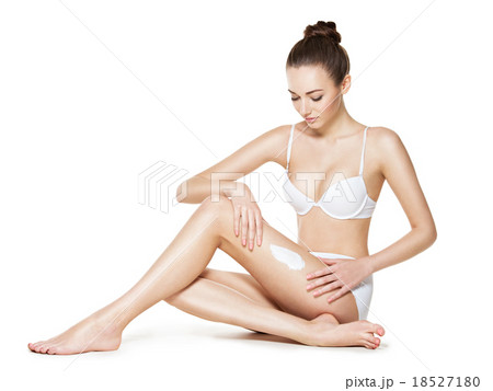 beautiful young woman depilating legs by waxing beautiful young woman depilating legs by waxing 18527180