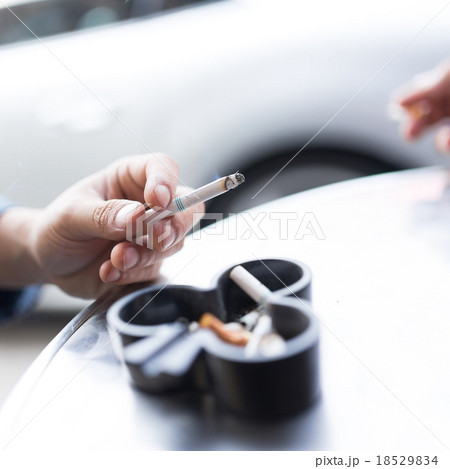 Man smoking cigarette and using an ashtray Man smoking cigarette and using an ashtray 18529834