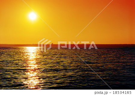 orange sunset over dark river orange sunset over dark river 18534165