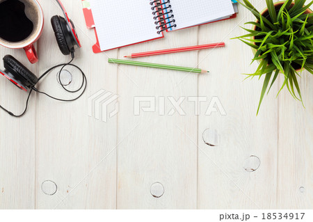 Desk with notepad, coffee and headphones Desk with notepad, coffee and headphones 18534917