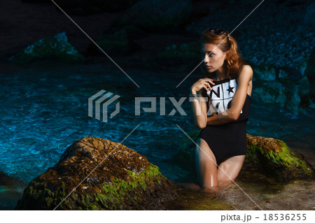 Young teen girl in sea fashion shoot at sunset 18536255