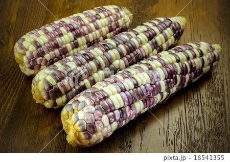 Purple organic corn on cob on wooden background Purple organic corn on cob on wooden background 18541355