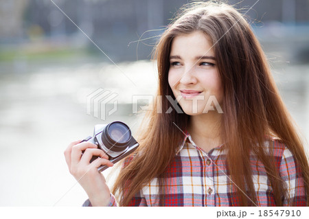 Portrait of a young woman with photo camera 18547910