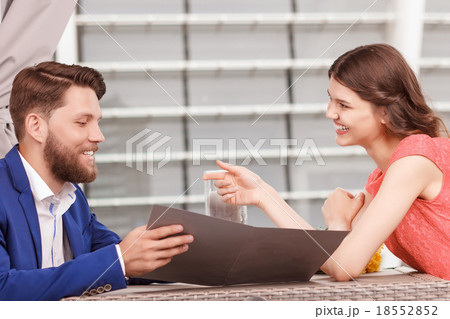 Lovely couple looking though menu 18552852