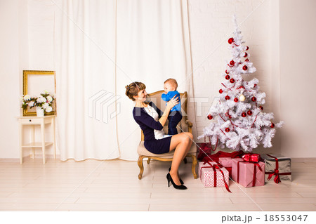 Smiling mother playing with  baby near Christmas 18553047