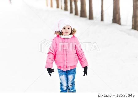 Happy baby girl in a winter park Happy baby girl in a winter park 18553049