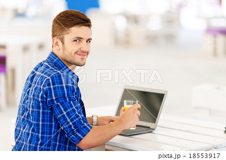 Positive freelancer working on the notebook Positive freelancer working on the notebook 18553917