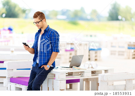 Pleasant guy holding mobile phone  18553931
