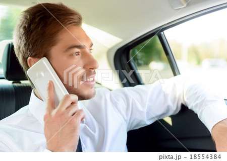 Successful businessman sitting in the car Successful businessman sitting in the car 18554384