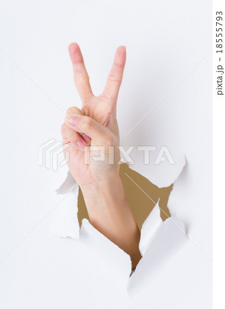 Woman hand breaking through paper wall pointing with the two fin 18555793