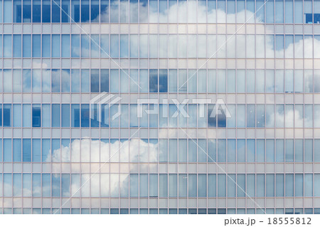 Cloud reflected in windows of modern office building 18555812