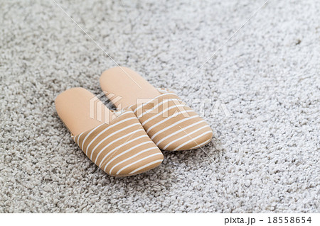 Pair of white slippers on a carpet Pair of white slippers on a carpet 18558654