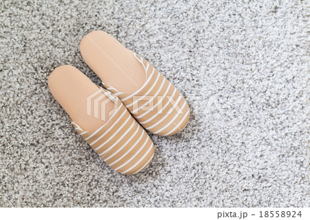 Pair of slippers on carpet 18558924