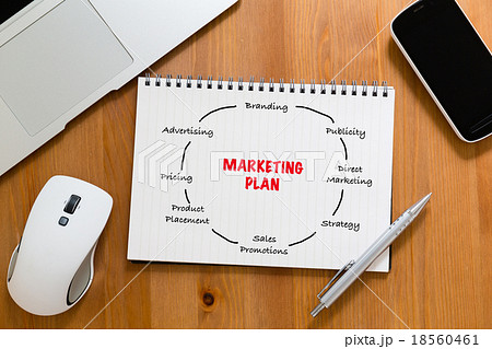 Office table with handbook drafting about marketing planning Office table with handbook drafting about marketing planning 18560461