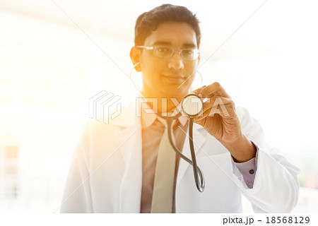 Asian Indian medical doctor holding stethoscope 18568129