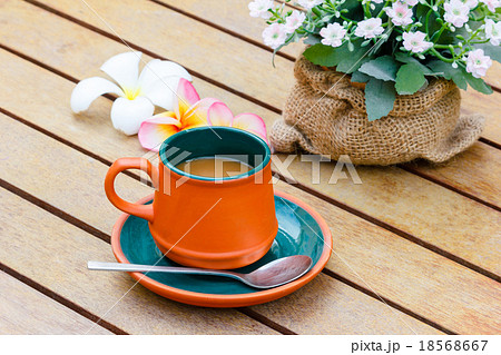 Hot coffee and notebook and flowers. Hot coffee and notebook and flowers. 18568667