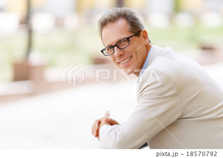 Pleasant man standing in the street Pleasant man standing in the street 18570792