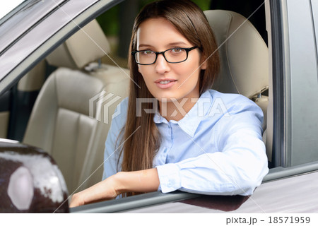Pleasant girl driving a car  18571959