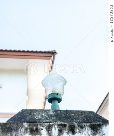 Looking up to Grunge lamp on pole in front house Looking up to Grunge lamp on pole in front house 18573853