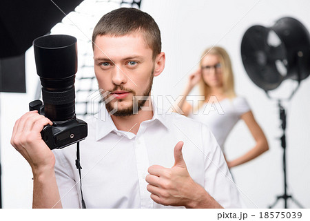 Young male photographer showing thumbs up Young male photographer showing thumbs up 18575039
