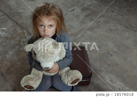 Lonely girl sitting on the suitcase  18576018