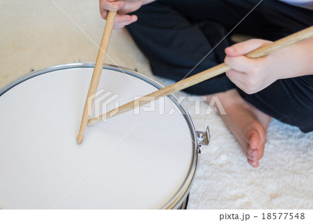 Boy teenager playing drums in room Boy teenager playing drums in room 18577548