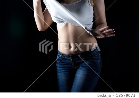 Undressing young woman in white vest Undressing young woman in white vest 18579073