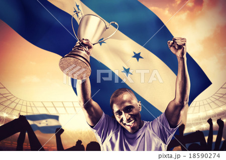 Composite image of portrait of happy sportsman cheering while ho Composite image of portrait of happy sportsman cheering while ho 18590274