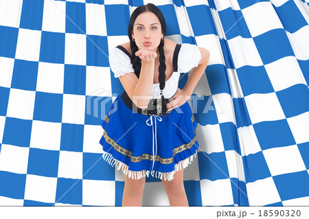 Composite image of pretty oktoberfest girl blowing a kiss Composite image of pretty oktoberfest girl blowing a kiss 18590320
