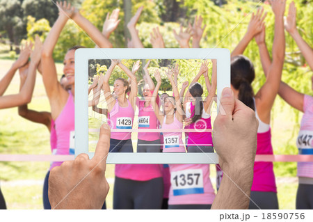 Composite image of hand holding tablet pc Composite image of hand holding tablet pc 18590756