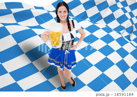 Composite image of pretty oktoberfest girl holding beer tankard Composite image of pretty oktoberfest girl holding beer tankard 18591184