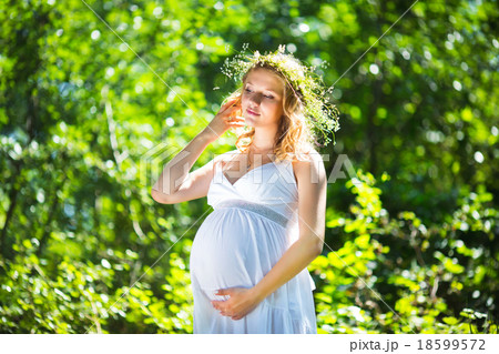Pregnant woman in green forest Pregnant woman in green forest 18599572