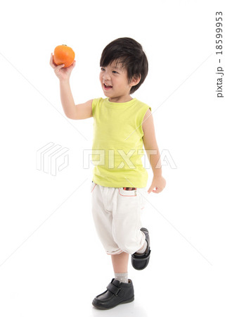 Cute asian boy holding persimmon Cute asian boy holding persimmon 18599953