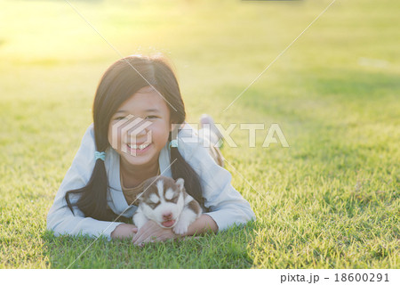 Cute asian girl lying with her puppy 18600291