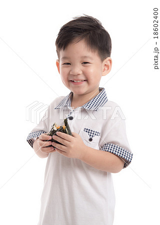 Cute asian child eating rice ball or onigiri Cute asian child eating rice ball or onigiri 18602400
