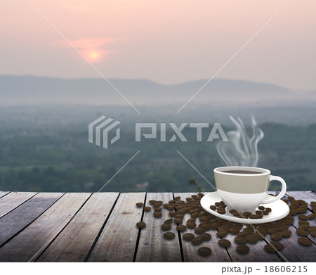 Cup with coffee on table over mountains landscape Cup with coffee on table over mountains landscape 18606215