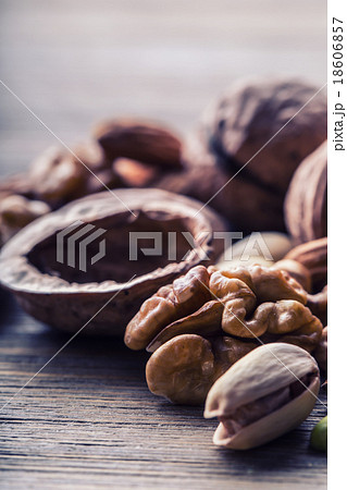 Almonds, walnuts and hazelnuts on wooden table Almonds, walnuts and hazelnuts on wooden table 18606857