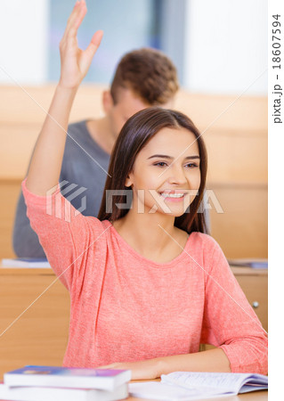 Smiling student wants to answer the question. 18607594